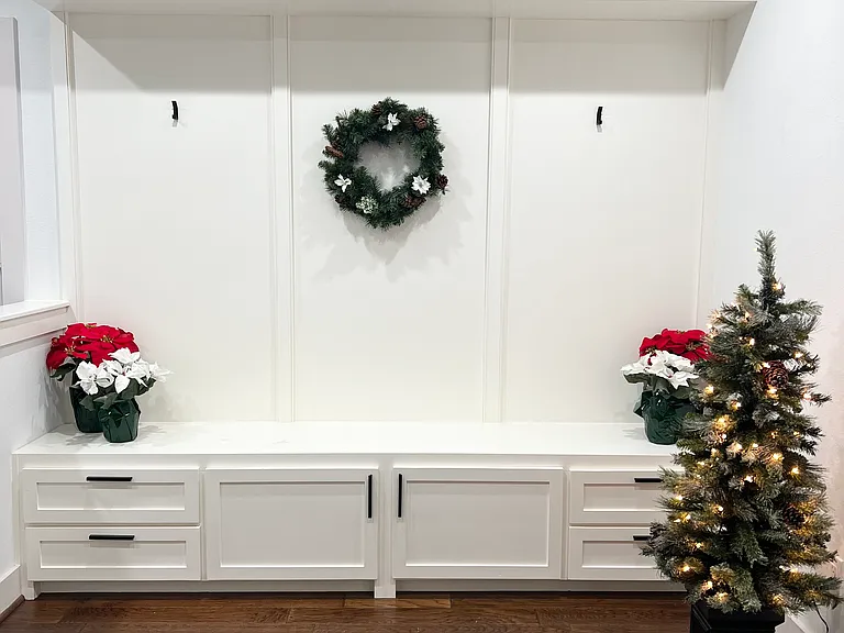 Entryway mud room with built-in cabintry with plenty of storage.