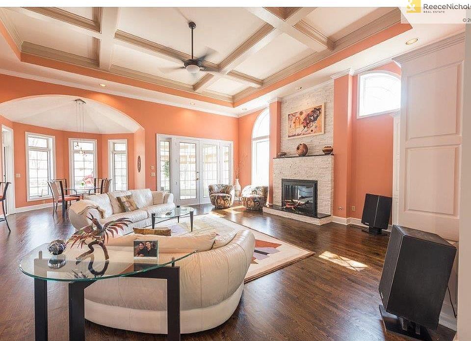 Open concept living/kitchen/breakfast room is flooded with natural light and warmth from the rich hardwood floors and cozy fireplace