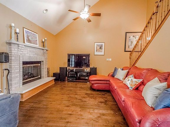 WOOD BURNING FIREPLACE, WITH GAS STARTER/INSERT IN GREAT ROOM W/VAULTED CEILINGS, HAND SCRAPPED HARDWOOD FLOORS, CAN LIGHT & DUAL CEILING FANS!  GREAT ROOM LEADS TO HUGE 3 SEASONS ROOM!