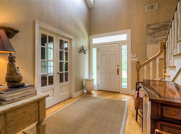 Welcoming 2-story foyer with office through double doors on the left.