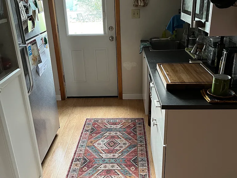 Another view of the galley kitchen. Front door opens to back yard.