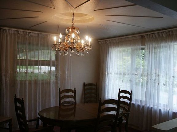 Fabulous sunburst designed ceiling is the feature of this gorgeous dining room