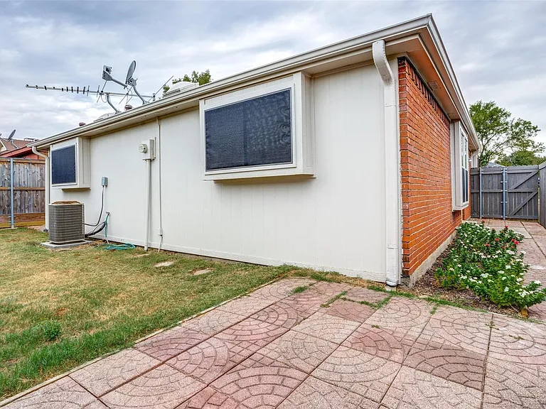 Rear view of property featuring a nice size backyard and patio area.