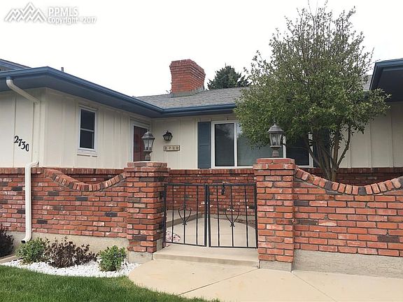 Fantastic courtyard with custom brickwork and iron gate.
