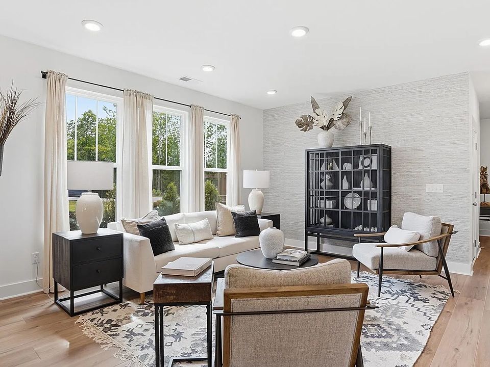 Spacious family room with rich hardwood flooring and elegant trim work in a reputable DRB Homes buil