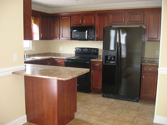 Kitchen with a Pantry & Black Appliances Included