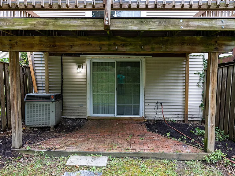 Brick paved patio and the sliding door to walkout from the basement.