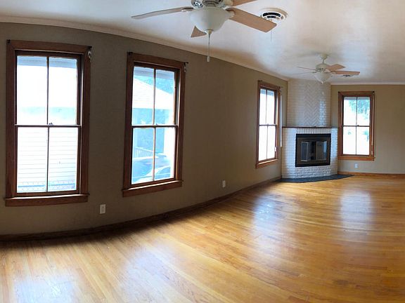 Huge Living Room with gorgeous wood floors and crown molding. 2 A/C vents, 2 ceiling fans, and a fireplace to keep you cozy no matter the season. (Nest Thermostat to reduce electricity costs)