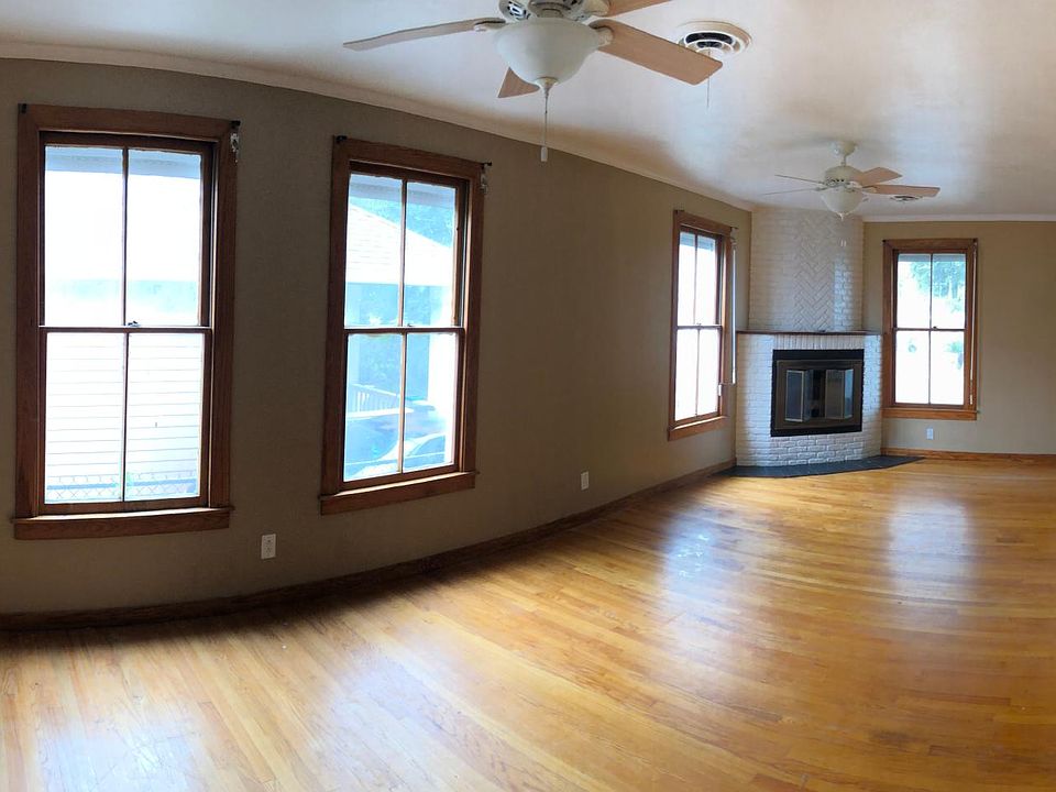 Huge Living Room with gorgeous wood floors and crown molding. 2 A/C vents, 2 ceiling fans, and a fireplace to keep you cozy no matter the season. (Nest Thermostat to reduce electricity costs)