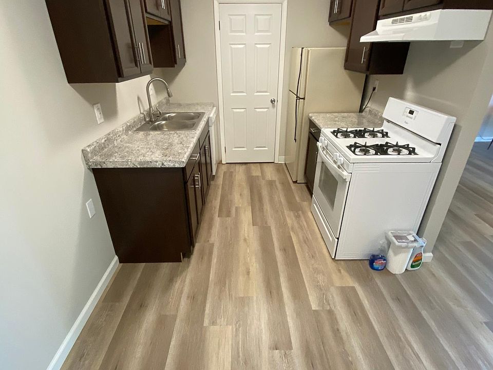 Kitchen with Stainless steel Stove hood, dual basin and High rise pullout spaying washer head, dishwasher, disposal refrigerator and Gas stove