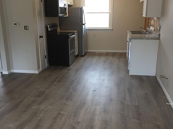 All new stainless steel appliances, cabinets & countertop. (View from living room)