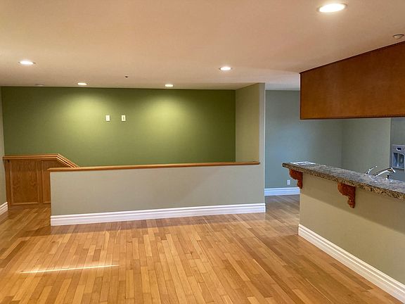 Opposite side of room, looking towards the stairs and dining area.