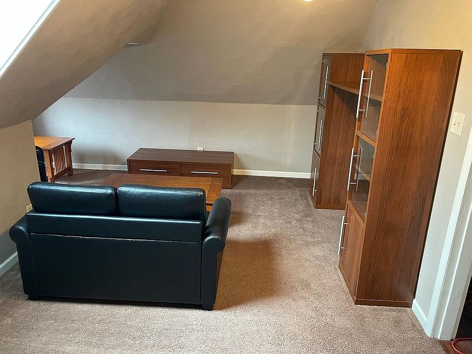 living room with book cases and seating