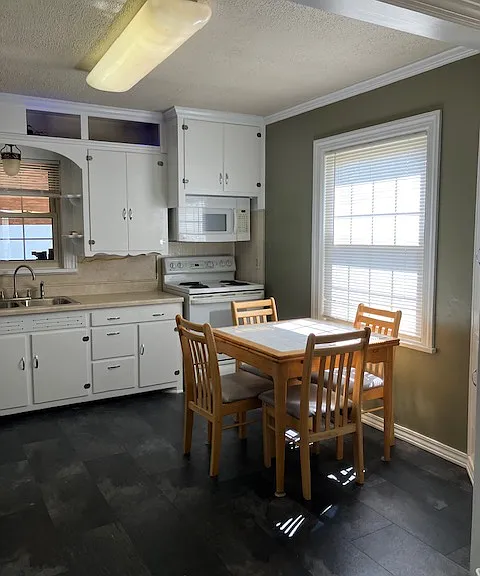 Kitchen with freshly painted cabinets and laminate flooring