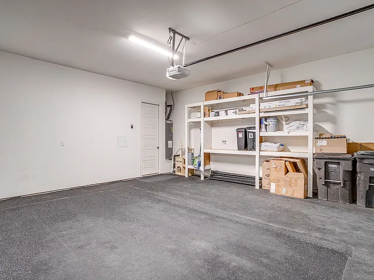 Two-car garage with exercise floor and built in storage shelves