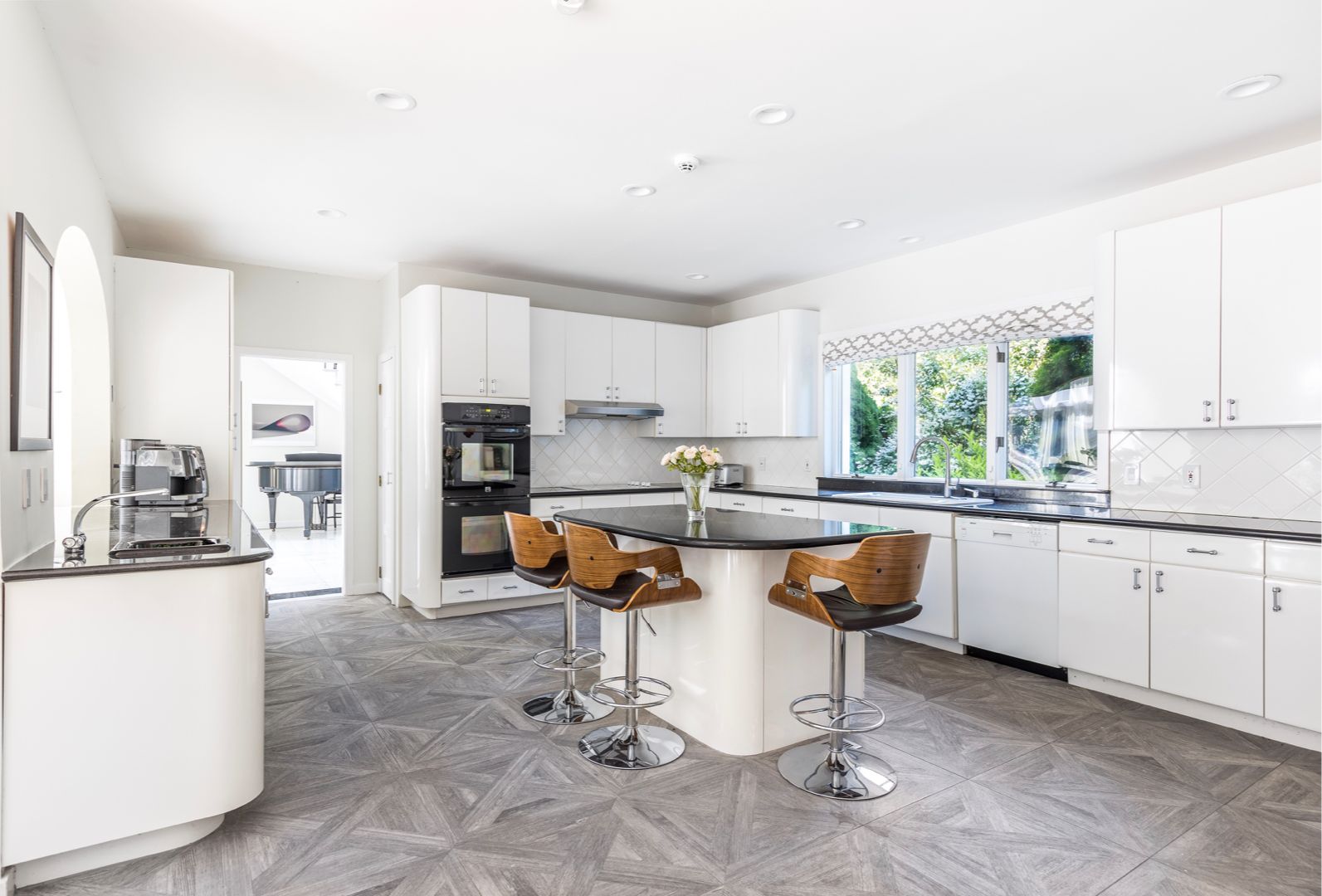  XL kitchen outfitted with 2 ovens, 2 sinks, wine cooler, dishwasher, kitchen bar seating.