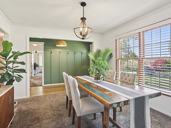 Bright dining room with large windows and natural light_perfect for everyday meals or hosting guests.