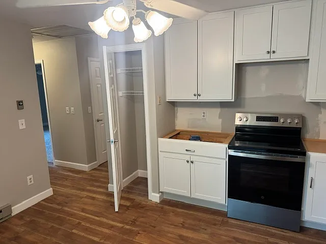 Kitchen to hallway, bedrooms, bath and hallway toward front door and large family room.