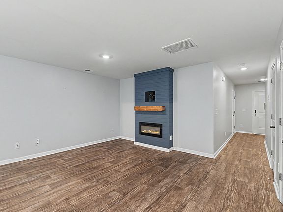 Large, open living area with electric fireplace