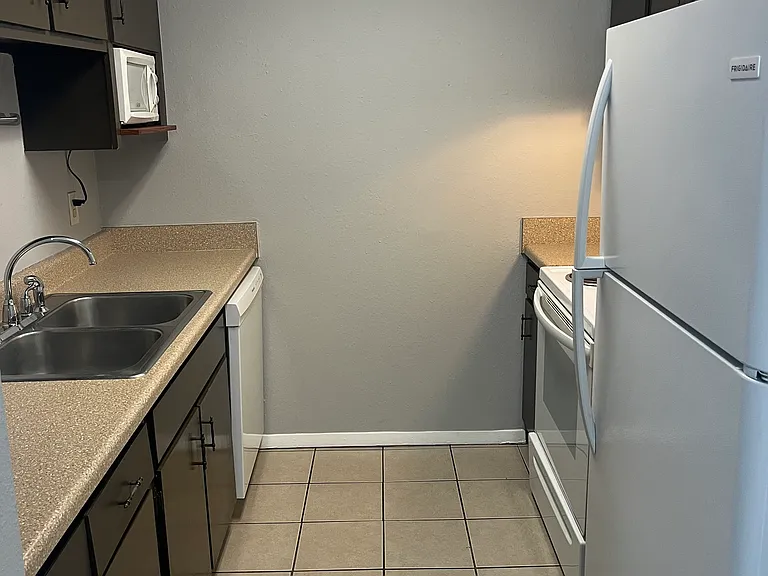 Kitchen with in-unit garbage disposal and appliances including microwave and dishwasher