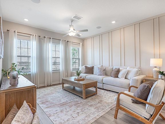 Enjoy a sunny, open living area - Photos showcase a model home with similar finishes, not the actual