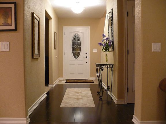 Updated foyer with bamboo hardwood floors with inlaid travertine tiles.