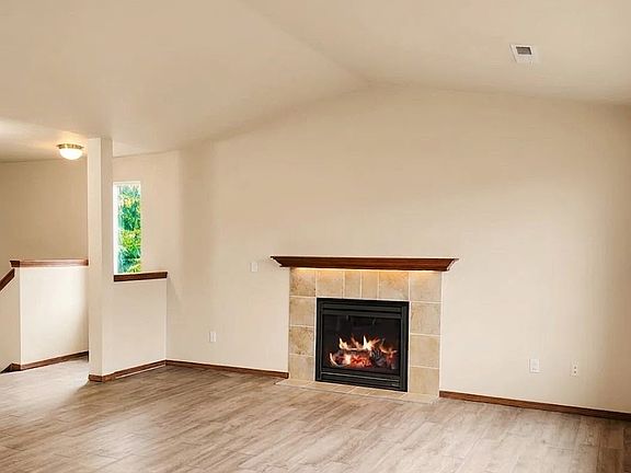 Spacious main living room with fireplace.