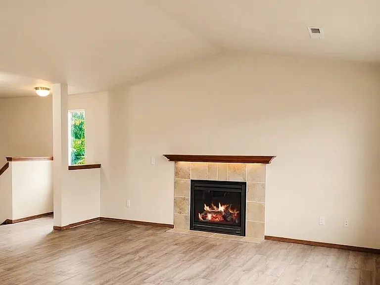 Spacious main living room with fireplace.