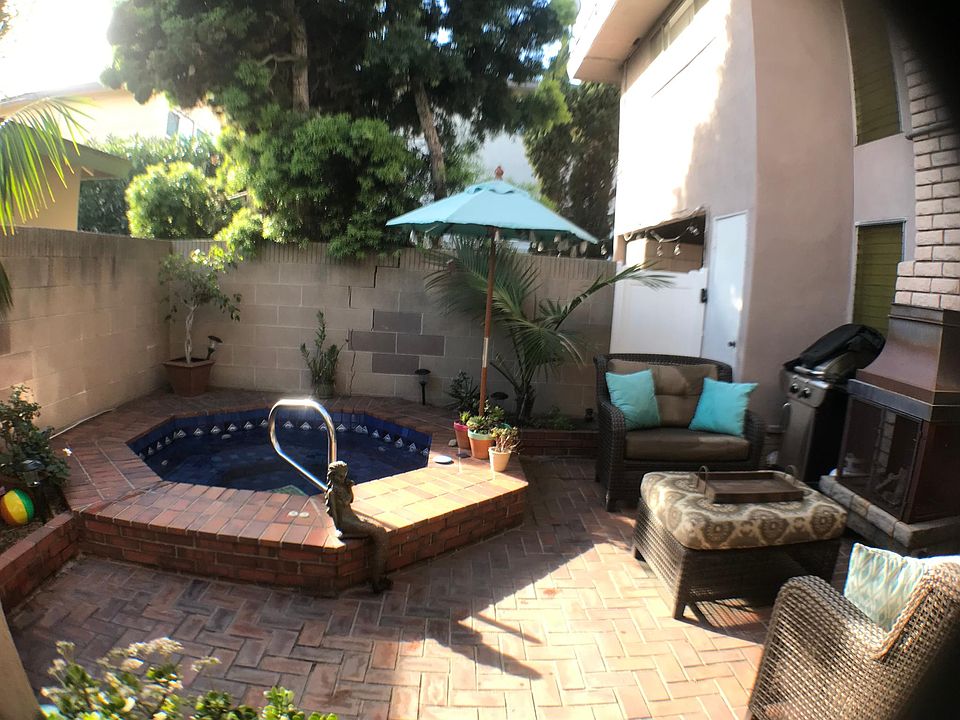Charming private back patio with hot tub. (Owner maintains hot tub.)