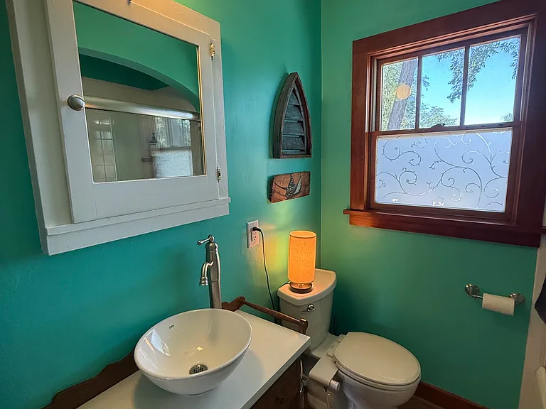 Main floor bath with vessel sink and decorative privacy window