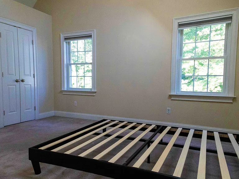 Primary bedroom full of lights and two large closets
