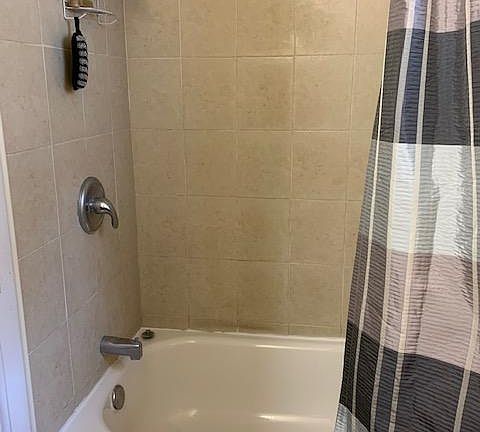 Full Bath with tiled walls and floor and vanity