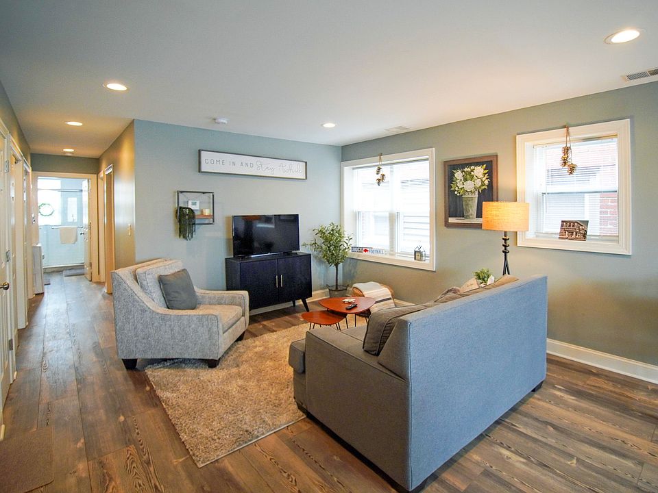 COZY LIVING ROOM WITH CLOSETS ALONG THE LEFT WALL.