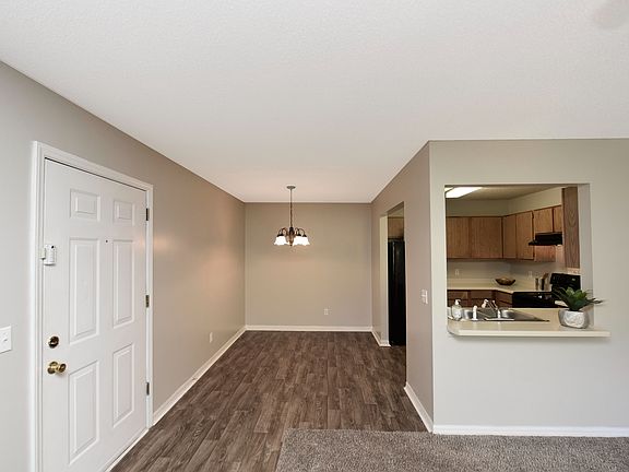 Step into modern living with this beautifully designed open-concept apartment featuring stylish flooring and a functional kitchen.