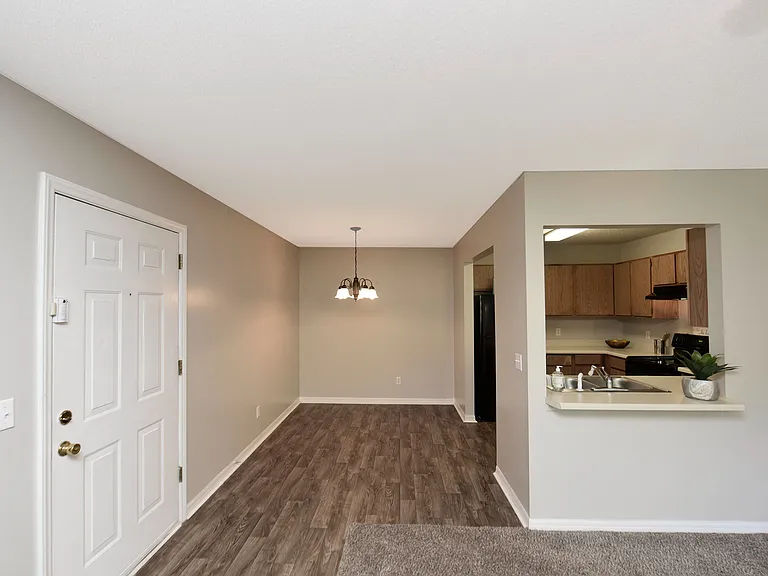 Step into modern living with this beautifully designed open-concept apartment featuring stylish flooring and a functional kitchen.