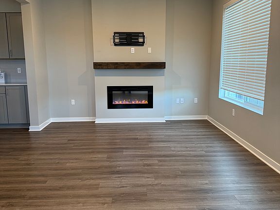 Sun_filled open floor plan with a designer electric fireplace and a 360_degree TV stand that accommodates up to a 65'' TV
