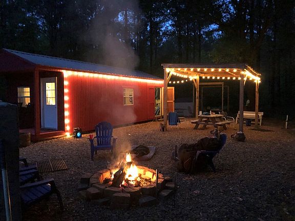 Relaxing camphouse with firepit and outbuildings