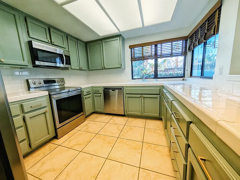 Ample kitchen featuring breakfast bar and stainless steel appliances.