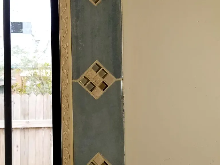 Tile and wood accents around prairie style windows in main room