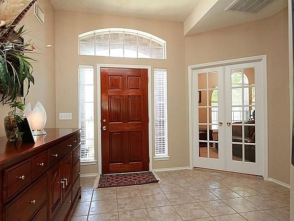 OPEN ENTRY WITH SIDE LIGHTS & TRANSOM WINDOW. DOUBLE 15 PANE FRENCH DOORS OPEN TO PRIVATE STUDY