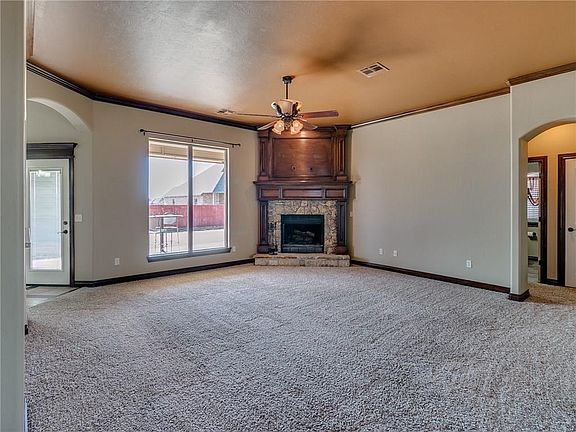 Large living with wood burning fireplace that has a gas starter.