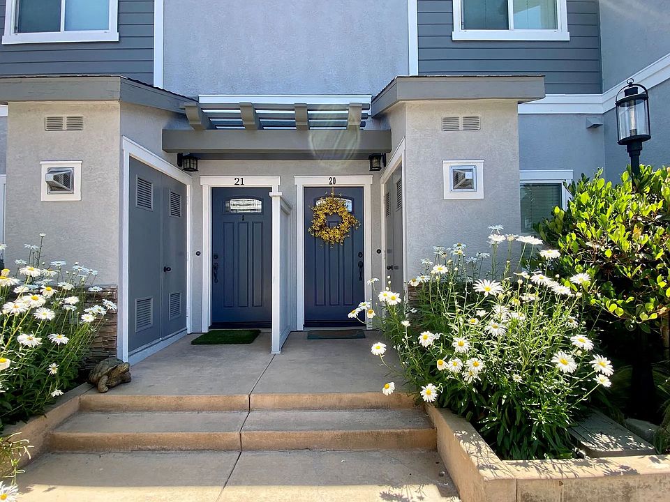 Front doors with beautiful planter gardens at The Nines Townhomes in Escondido, California.