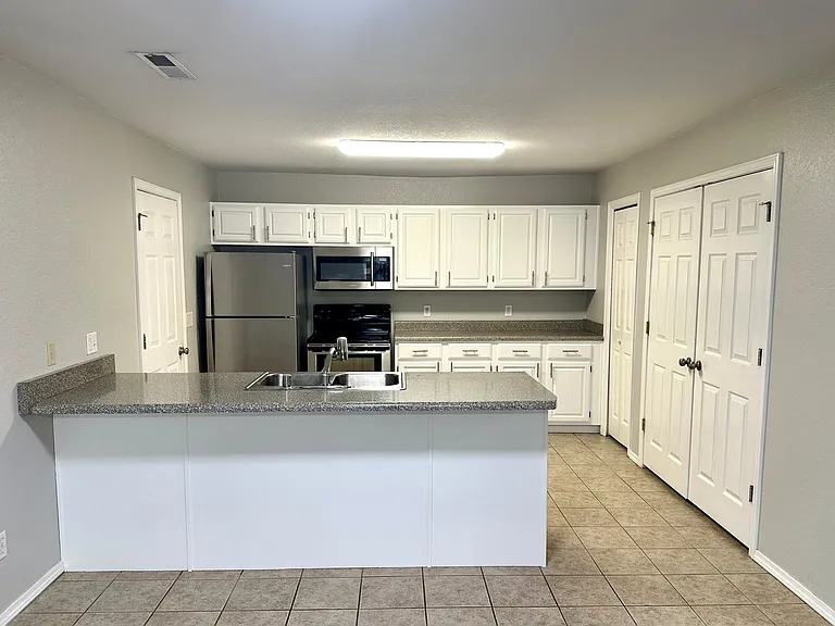 Updated kitchen featuring stainless steel appliances, updated cabinets, pantry and laundry room.