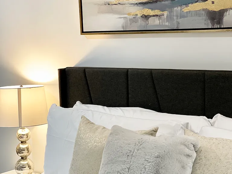 Apartment Bedroom with 65 inch TV and king size bed