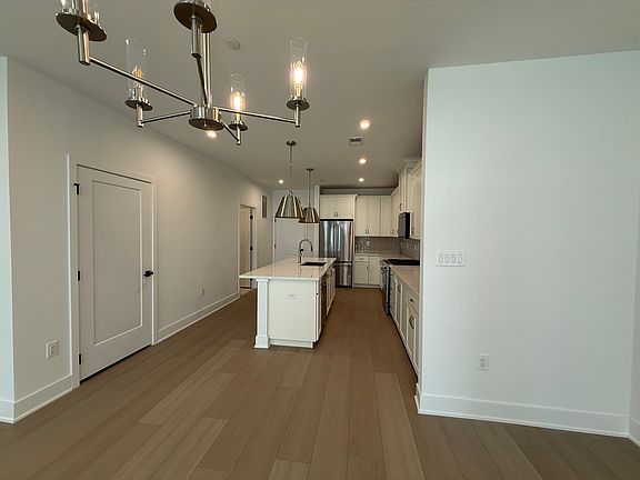 Kitchen showing pantry and full bath doors