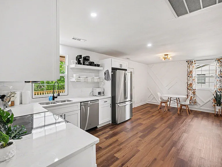 Open kitchen with ample counter space, stainless appliances, and adjacent dining nook for everyday meals.