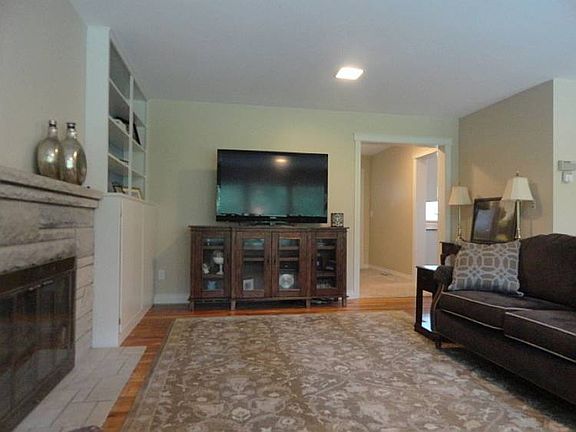 The stone fireplace in this mid century home is not just a simple surround around the fireplace box itself, but is instead several feet of beautiful light grey authentic stone.