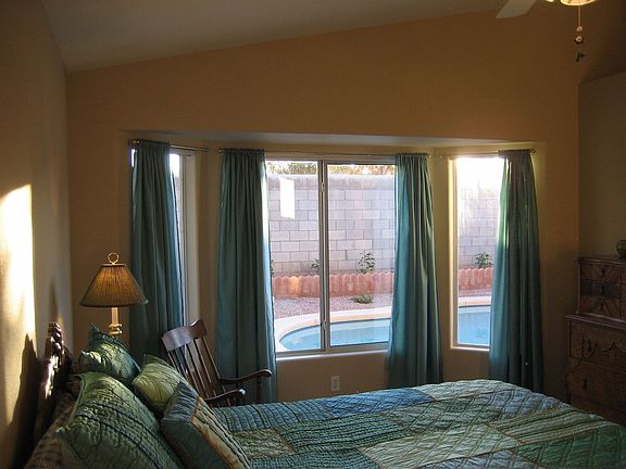 A large master bedroom witha bay/picture window.