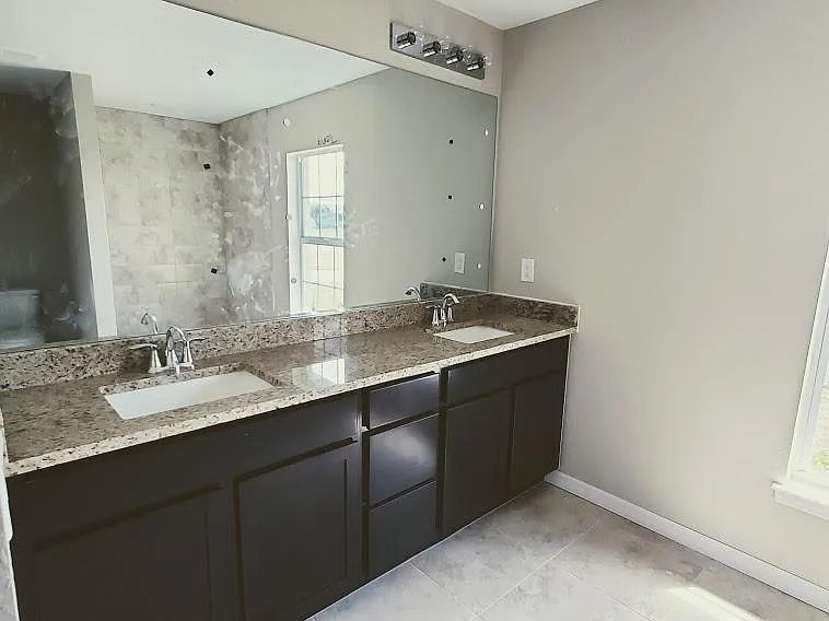 master bath with granite double sink vanity