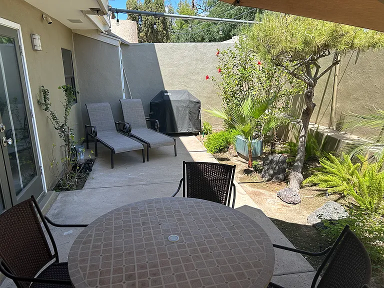 Back patio of unit with Weber BBQ and table for 4